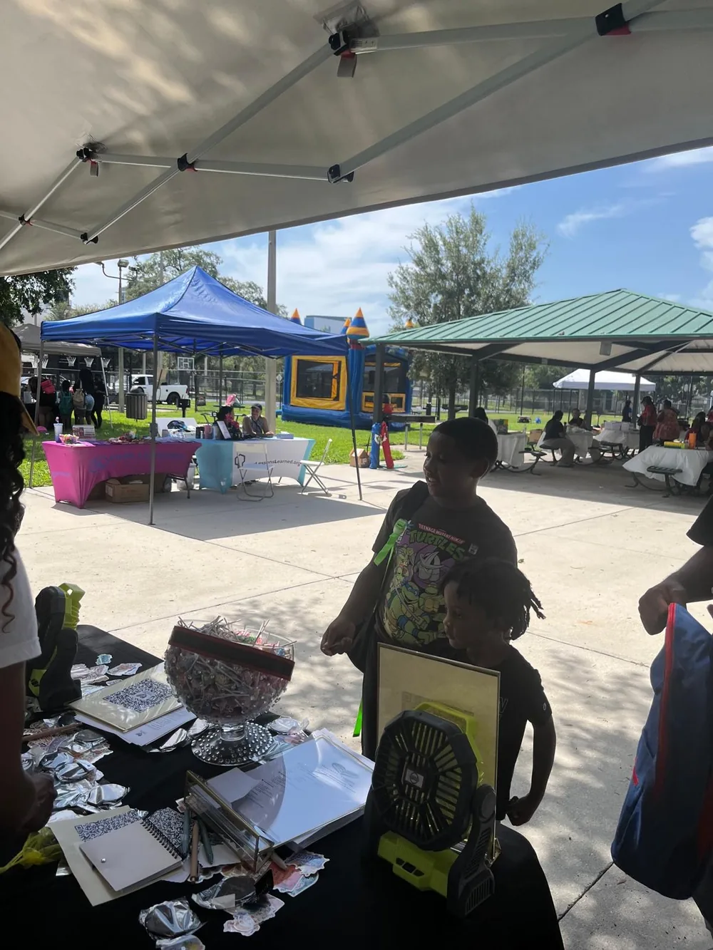 The event grounds at Callahan Neighborhood Center with tents, tables, and a bounce house